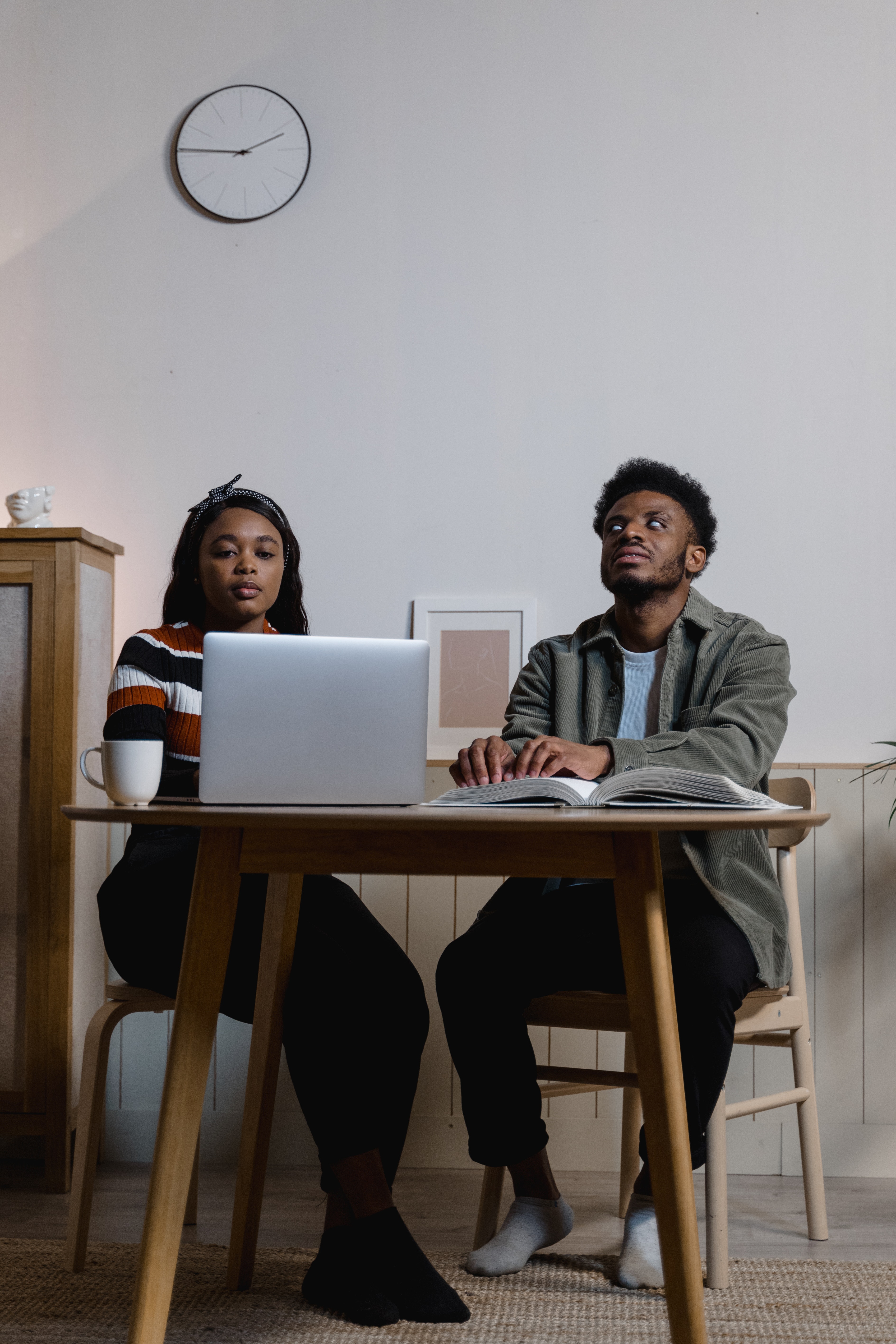 A person helping a blind person use the computer