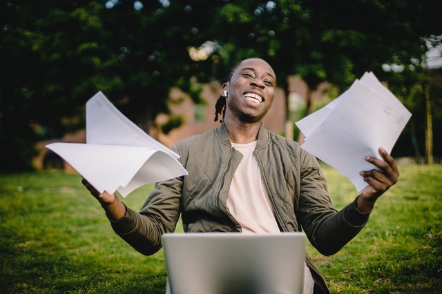 man holding paper and converting to digital files