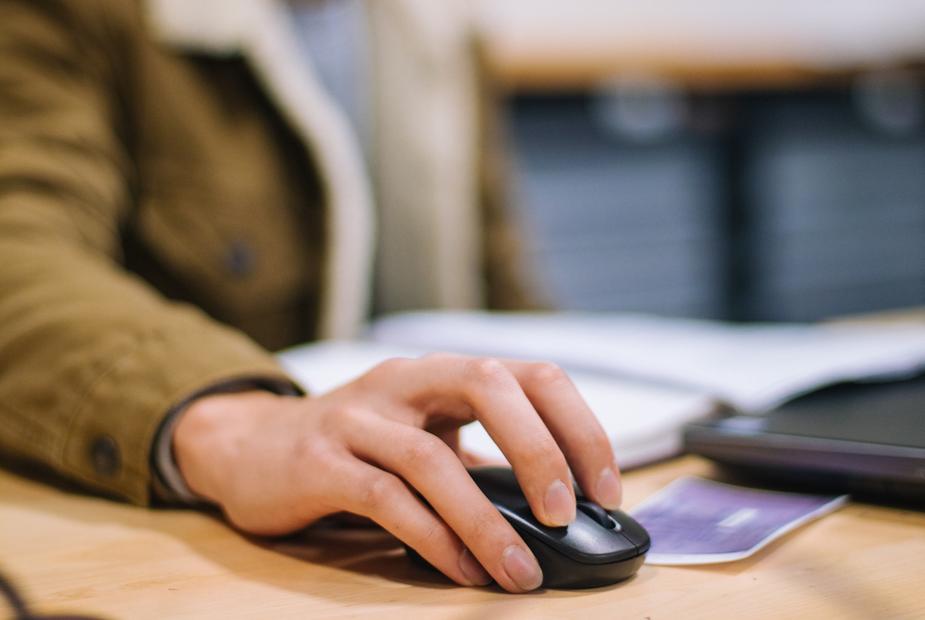 person using a computer to save Word to PDF