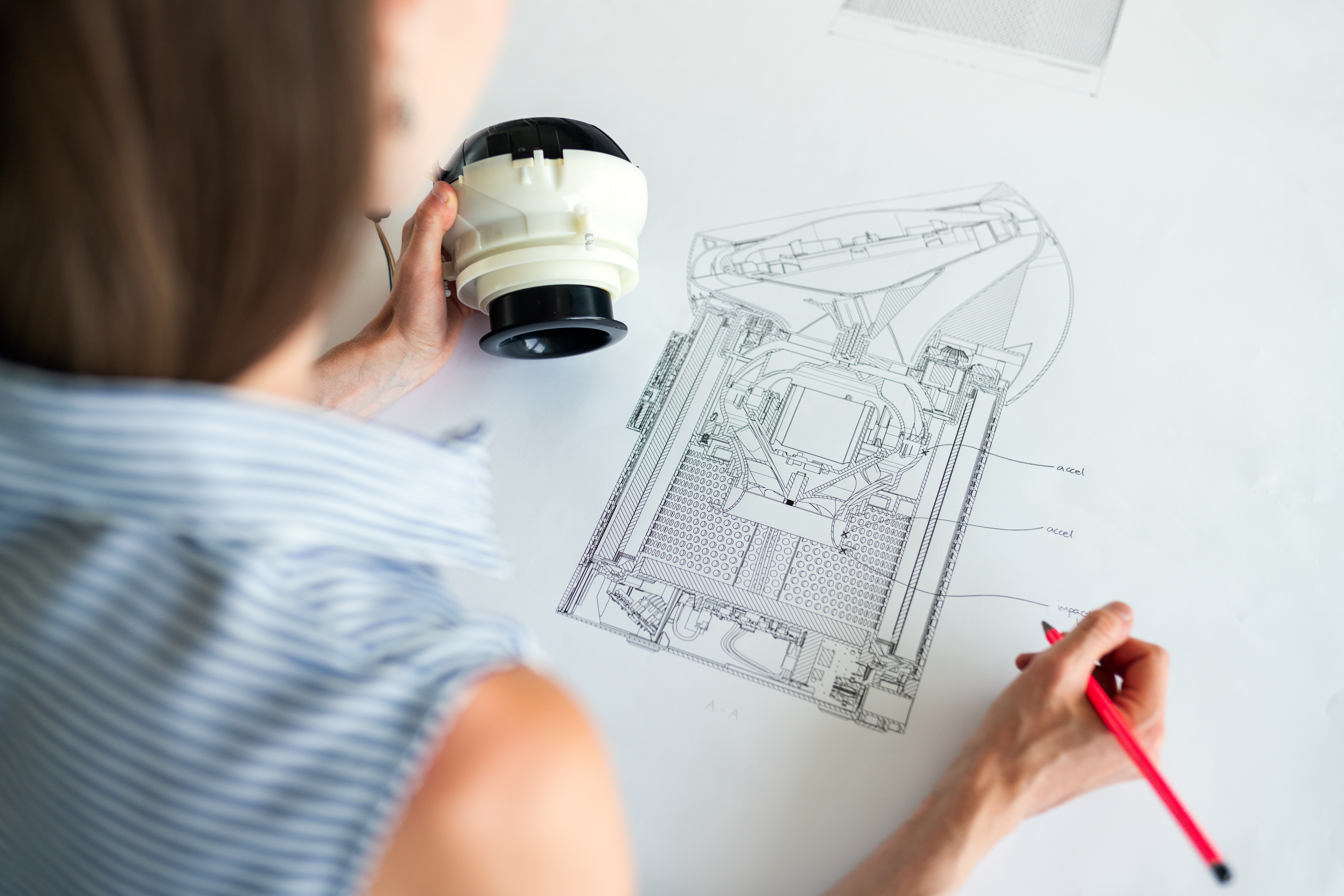 woman drawing blueprint for engineering